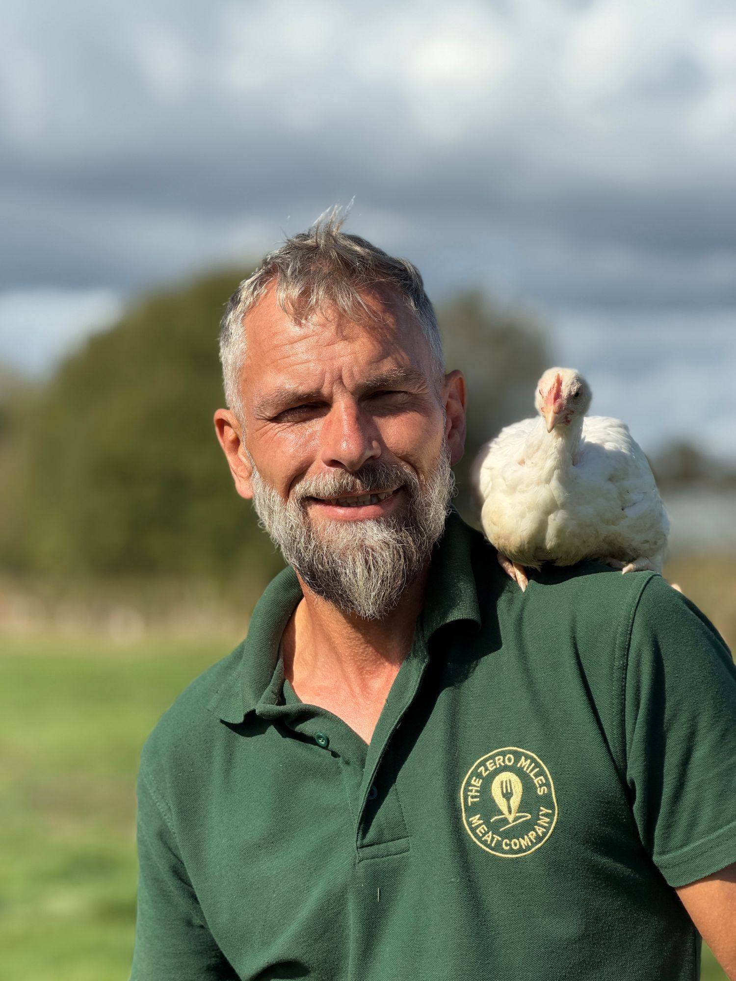 A Zero Miles farmer with one of their pasture-raised birds